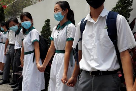 Secondary school students form a human chain against extradition bill in Hong Kong