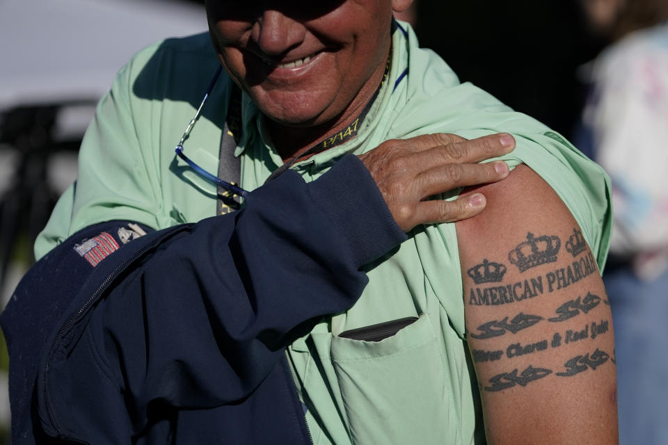 Kevin McKathan, trainer of Preakness entrant Fenwick, displays his tattoo honoring triple crown winner American Pharoah, as he stands near the stables after Fenwick worked out ahead of the Preakness Stakes Horse Race at Pimlico Race Course, Wednesday, May 18, 2022, in Baltimore. Fenwick has a 50-1 shot of winning the race. (AP Photo/Julio Cortez)