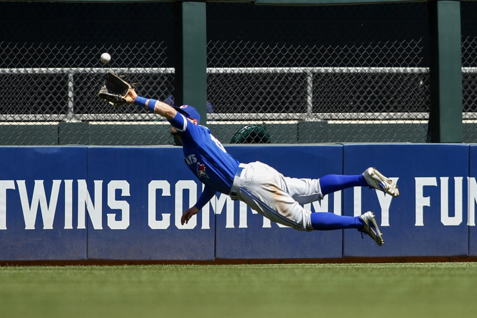 <p>Toronto Blue Jays center fielder Kevin Pillar dives for and catches a fly ball hit by Minnesota Twins’ Brian Dozier in the fifth inning of a baseball game, May 22, 2016, in Minneapolis. (Bruce Kluckhohn/AP) </p>