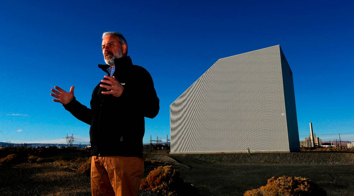 John Eschenberg, president of Central Plateau Cleanup Co., shows off the recently completed “cocooning” of the K East Reactor at Hanford. The K West Reactor, yet to be cocooned, is in the background.