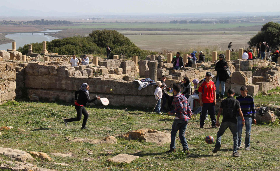 In this March 11, 2012 photo, Moroccan college students play in the Roman ruins of Lixus in northern Morocco. (AP Photo/Paul Schemm)