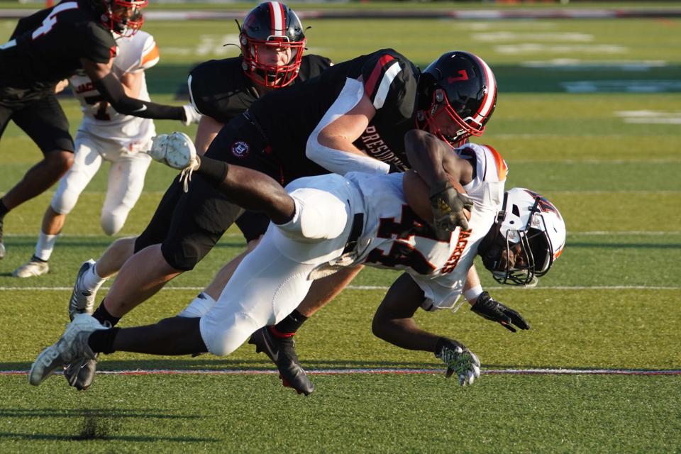 Marion Harding's Landon Adams tackles Mount Vernon's Jonny Askew during the season opening high school football game at Harding Stadium last week.