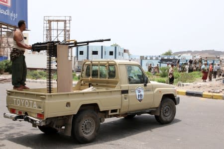 Members of UAE-backed southern Yemeni separatist forces patrol a road during clashes with government forces in Aden, Yemen