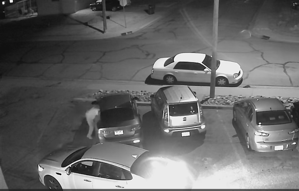 A photograph from a security system shows a man enter a Kia owned by a resident of Pueblo, Colo., through a window. The thief left with the car less than two minutes after hotwiring it. Spurred by a social media trend, thefts of Kia and Hyundai vehicles have been on the rise nationally.