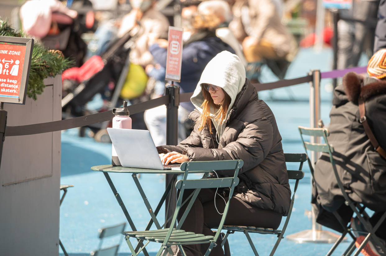 A person works on her laptop at the Bank of America Winter Village in Bryant Park amid the coronavirus pandemic on March 14, 2021 in New York City. (Noam Galai/Getty Images)