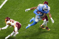 Detroit Lions running back D'Andre Swift (32) avoids a tackle by Washington Football Team cornerback Jimmy Moreland (20) and inside linebacker Jon Bostic (53) before falling into the end zone for a touchdown during the second half of an NFL football game, Sunday, Nov. 15, 2020, in Detroit. (AP Photo/Carlos Osorio)