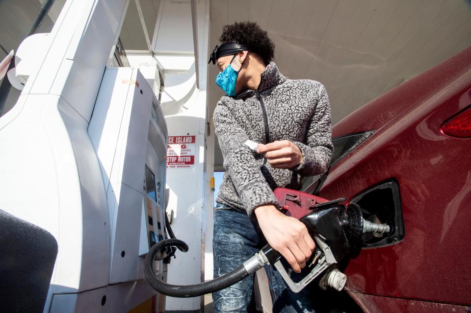 Tynell Lopez fills up his car gas tank on Feb. 15 at the Shell station located on East Sixth and Parade streets in Erie.