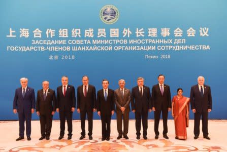 Foreign ministers and officials of the Shanghai Cooperation Organisation (SCO) pose for a group photo before a meeting at the Diaoyutai State Guest House in Beijing, China, April 24, 2018. From left: SCO Secretary-General Rashid Alimov, Uzbek Foreign Minister Abdulaziz Kamilov, Tajik Foreign Minister Sirojidin Aslov, Russian Foreign Minister Sergei Lavrov, Chinese State Councilor and Foreign Minister Wang Yi, Pakistan Foreign Minister Khawaja Muhammad Asif, Kyrgyz Foreign Minister Erlan Abdyldaev, Kazakh Foreign Minister Kairat Abdrakhmanov, Indian Foreign Minister Sushma Swaraj, SCO Regional Anti-Terrorist Structure Director Yevgeniy Sergeyevich Sysoyev. MADOKA IKEGAMI/Pool via REUTERS