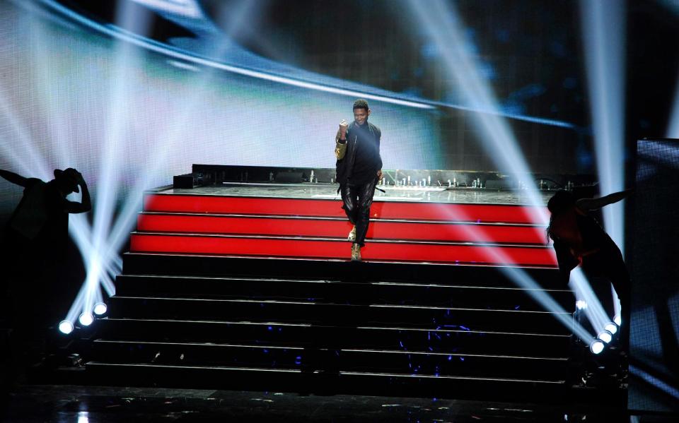 Usher performs during the world premiere of Michael Jackson's song "Love Never Felt So Good" at the iHeartRadio Music Awards at the Shrine Auditorium on Thursday, May 1, 2014, in Los Angeles. (Photo by Chris Pizzello/Invision/AP)