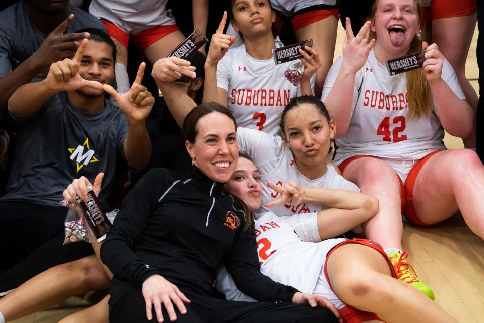 York Suburban head coach Jess Weaver joins in for photos with the team and student section after the Trojans defeated West York, 37-34, in a District 3 Class 5A semifinal game Tuesday, Feb. 27, 2024, in Spring Garden Township.
