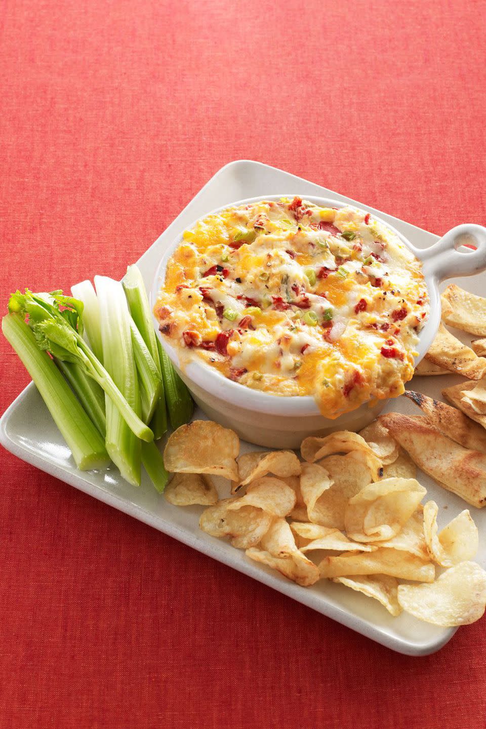 <p>Pull this gooey dip out of the oven right before guests arrive for an appetizer that'll keep them happy until it's time for dinner.</p><p><strong><a href="https://www.womansday.com/food-recipes/food-drinks/recipes/a12205/warm-pimiento-cheese-dip-recipe-wdy1112/" rel="nofollow noopener" target="_blank" data-ylk="slk:Get the recipe.;elm:context_link;itc:0;sec:content-canvas" class="link ">Get the recipe.</a></strong></p>