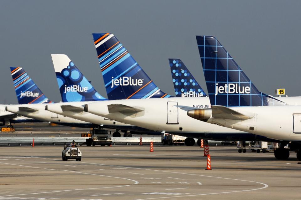 A line of JetBlue tail fins.