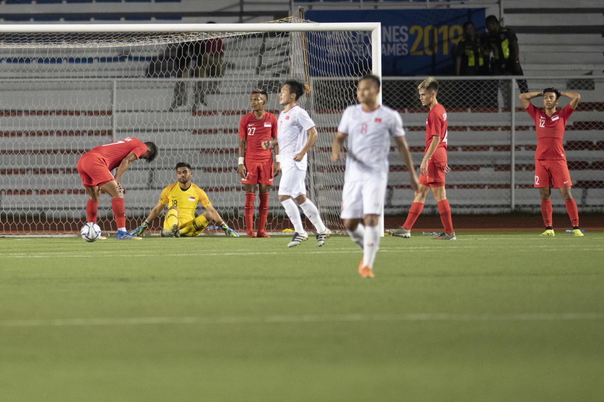 Singapore players react with dismay after conceding a late winning goal to Vietnam at the SEA Games football competition. (PHOTO: SNOC/Lim Weixiang)