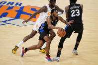New York Knicks guard Immanuel Quickley (5) drives past Orlando Magic forward James Ennis III, left and teammate Knicks center Mitchell Robinson (23) during the first half of an NBA basketball game, Monday, Jan. 18, 2021, in New York. (AP Photo/Kathy Willens, Pool)