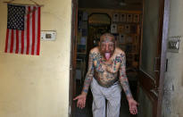 <p>Guinness Rishi, 74, multiple world record holder including most flags tattooed on his body, poses for a photograph outside his apartment in New Delhi, India May 20, 2016. (Cathal McNaughton/REUTERS) </p>