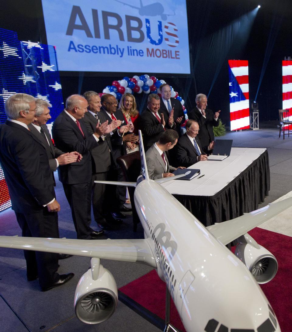 Alabama Gov. Robert Bentley, seated at right, and Airbus President & CEO Fabrice Bregier sign an agreement that Airbus will establish its first assembly plant in the United States in Mobile, Ala., Monday, July 2, 2012. The French-based company said the Alabama plant is expected to cost $600 million to build and will employ 1,000 people when it reaches full production, likely to be four planes a month by 2017. (AP Photo/Dave Martin)