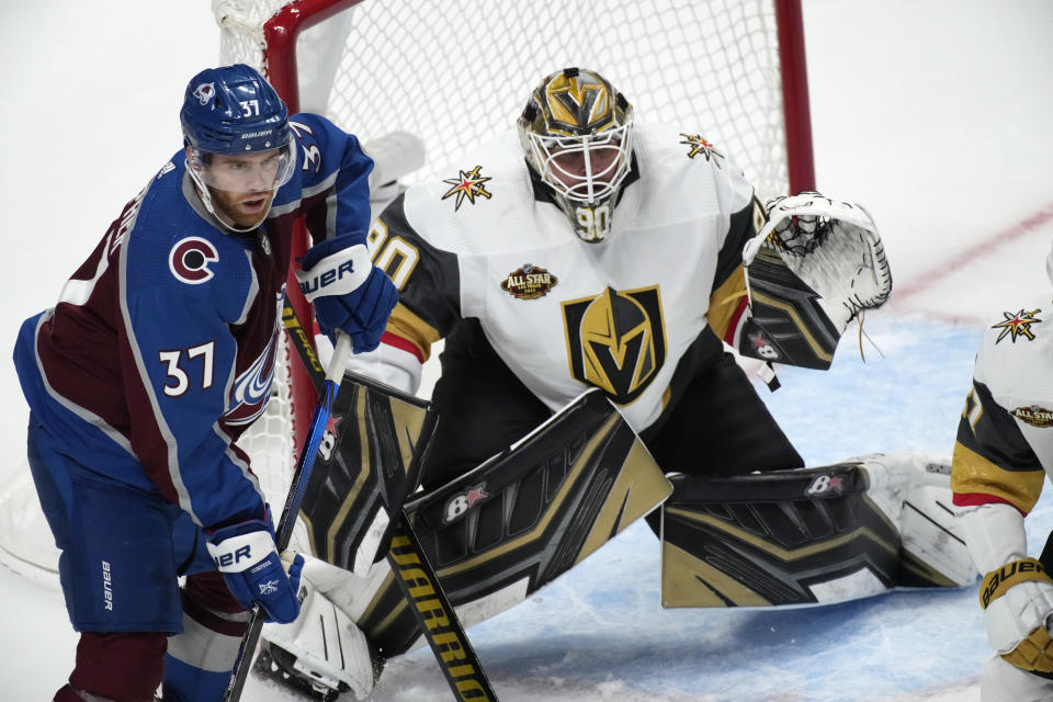 Vegas Golden Knights goalie Robin Lehner, right, protects the net as Colorado Avalanche left wing J.T. Compher waits for a pass in the third period of an NHL hockey game Tuesday, Oct. 26, 2021, in Denver. The Golden Knights won 3-1. (AP Photo/David Zalubowski)