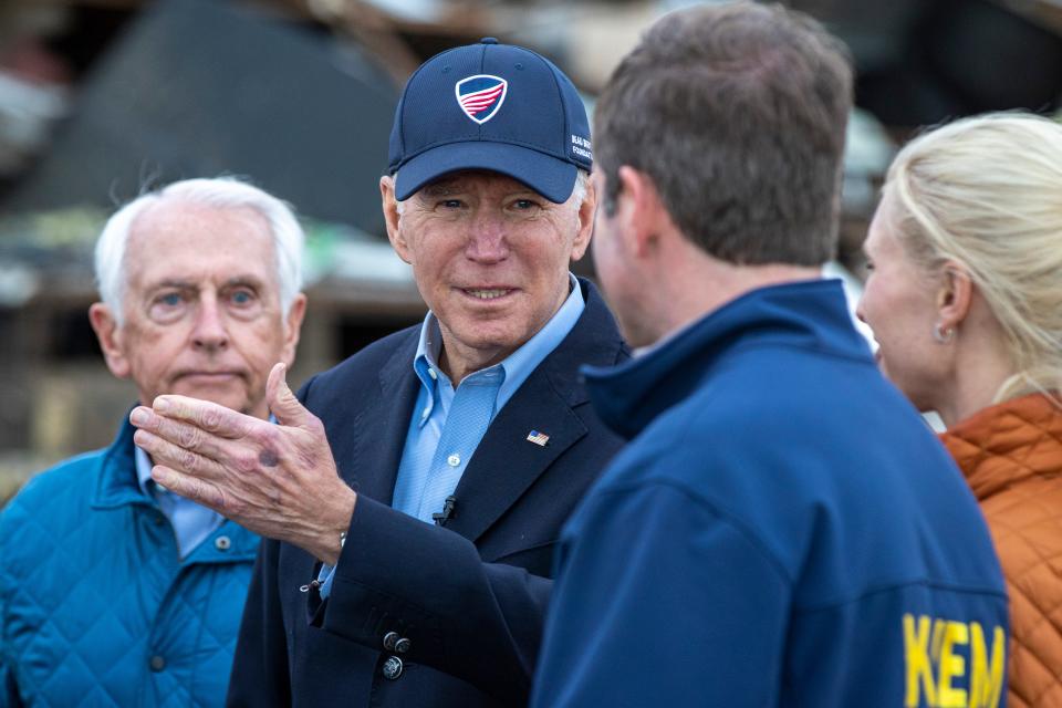 Gov. Andy Beshear, right, talks with Pres. Joe Biden as Biden toured the tornado devastation in Dawson Springs, Ky. on Wednesday evening. Dec. 15, 2021
