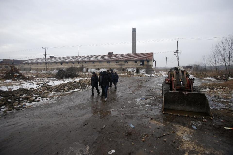 Migrants walk by an abandoned brick factory in the northern Serbian town of Subotica, near the border between Serbia and Hungary, Wednesday, Feb. 1, 2017. Thousands of migrants have been stranded in Serbia and looking for ways to cross illegally into the European Union. (AP Photo/Darko Vojinovic)