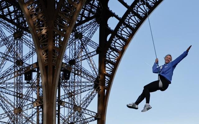 Woman rope climber scales Eiffel Tower with bare hands in record