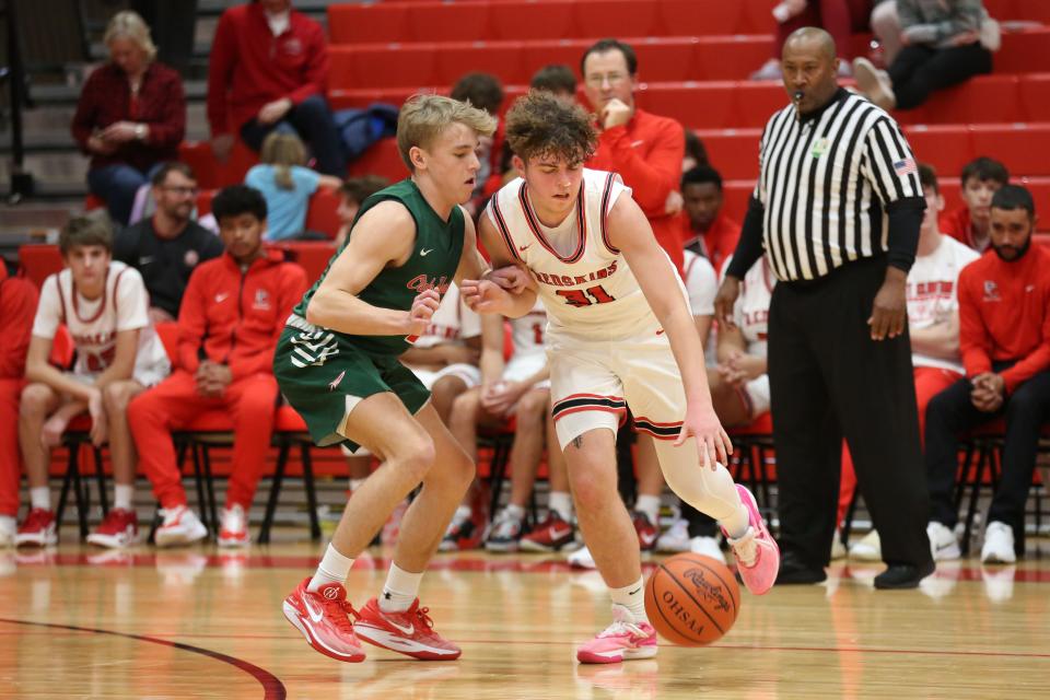 Port Clinton's James Crowe handles the ball as Oak Harbor's Carson Slates defends.