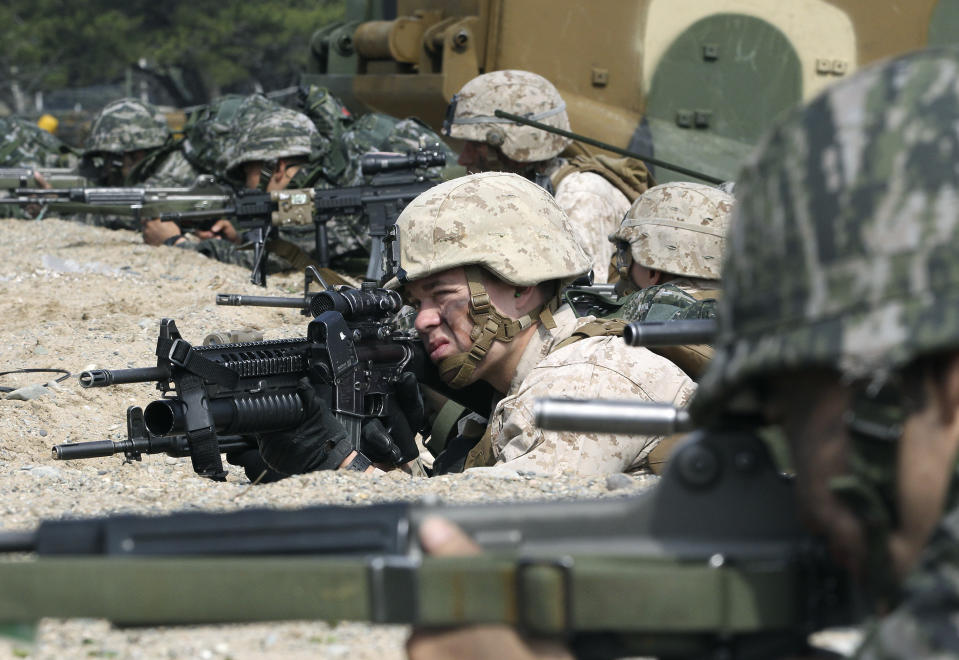 South Korean and U.S. Marines aim their machine gunds during the U.S.-South Korea joint landing exercises called Ssangyong, part of the Foal Eagle military exercises, in Pohang, South Korea, Monday, March 31, 2014. South Korea says North Korea has announced plans to conduct live-fire drills near the rivals' disputed western sea boundary. The planned drills Monday come after an increase in threatening rhetoric from Pyongyang and a series of rocket and ballistic missile launches in an apparent protest against the annual military exercises by Seoul and Washington. (AP Photo/Ahn Young-joon)