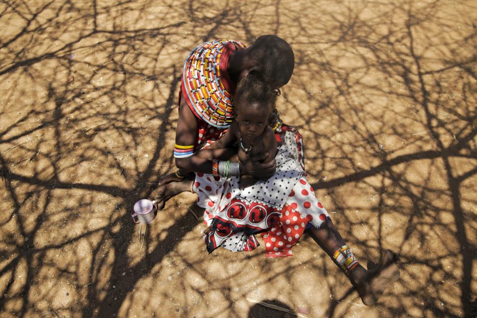 Nalangu Lekoomet weeps as she holds her malnourished son Peisaal Loitibik in West Gate Village, Samburu County, Kenya, on Oct. 13, 2022. She explains that the 2-year-old collapsed because of starvation. (AP Photo/Brian Inganga)