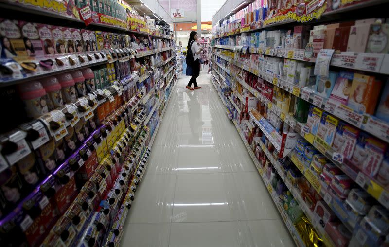 A shopper looks at items at a drug store in Tokyo