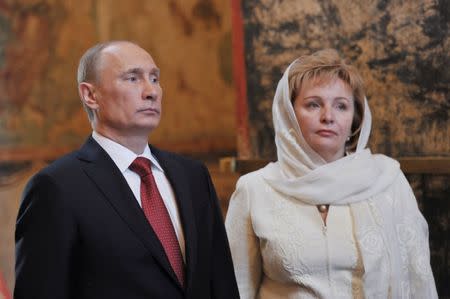 FILE PHOTO: Vladimir Putin (L) and his wife Lyudmila attend a service, conducted by Patriarch of Moscow and All Russia Kirill, to mark the start of his term as Russia's new president at the Kremlin in Moscow, May 7, 2012. REUTERS/Aleksey Nikolskyi/RIA Novosti/Pool/File Photo
