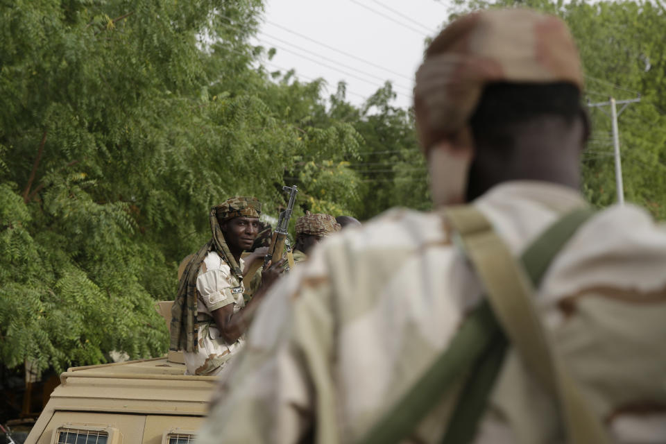 Chadian soldiers escorting a group of journalists ride on trucks and pickups in the Nigerian city of Damasak, Nigeria, Wednesday March 18, 2015. (AP Photo/Jerome Delay)
