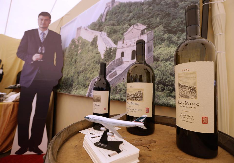 In this photo taken Friday May 31, 2013, Yao Ming Family Wines are on display during the barrel auction event of Auction Napa Valley at Raymond Vineyards in St. Helena, Calif. Forget the tie. Think bespoke booze for Father’s Day, specifically a beverage tailor-made to suit the hobbies father knows best. There are a lot of people to look up to in the world of wine but maybe none so literally as 7-foot-6 former NBA star Yao Ming. (AP Photo/Eric Risberg)