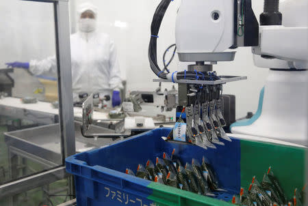 Kawasaki Heavy Industries' collaborative robot stacks rice balls at Delicious Cook &Co's food factory in Narashino, Japan, April 17, 2018. REUTERS/Toru Hanai