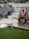 Austin FC defender Julio Cascante sits on the bench after the team's loss to the San Jose Earthquakes in an MLS soccer match Saturday, Sept. 18, 2021, in Austin, Texas. The Earthquakes won 4-3. (AP Photo/Michael Thomas)