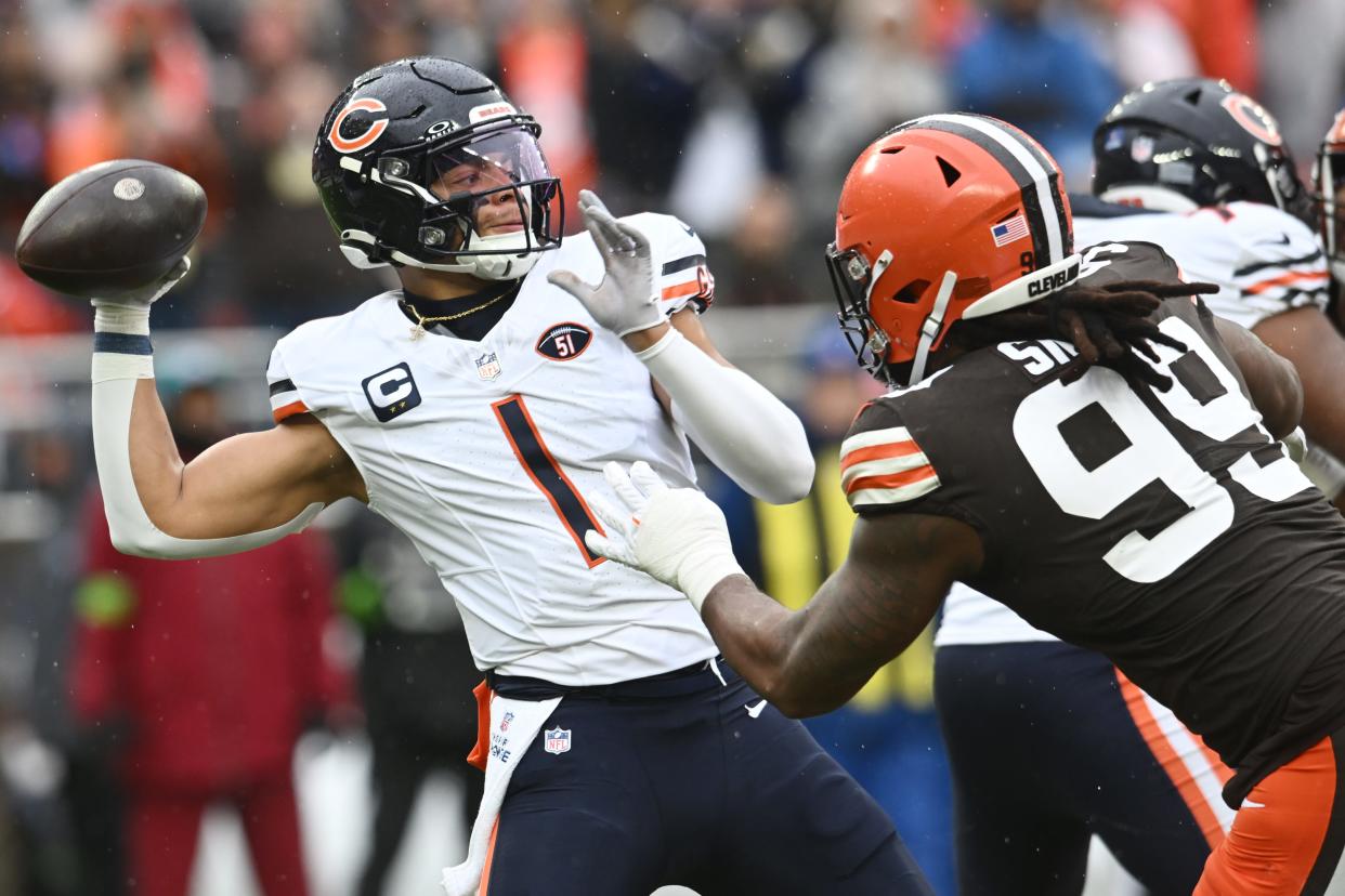 Chicago Bears quarterback Justin Fields (1) throws a pass as Cleveland Browns defensive end Za'Darius Smith (99) rushes Dec. 17, 2023, in Cleveland.
