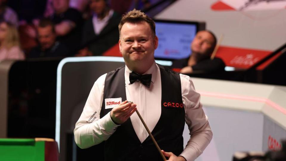 Shaun Murphy smiles as he chalks his cue