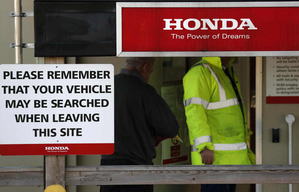 Security guards the entrance of the Honda car factory in Swindon, England, Tuesday, Feb. 19, 2019. The Japanese carmaker Honda announced Tuesday that its car plant in Swindon will close with the potential loss of some 3,500 jobs. (AP Photo/Frank Augstein)