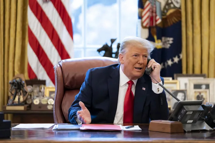 In this image released in the final report by the House select committee investigating the Jan. 6 attack on the U.S. Capitol, on Thursday, Dec. 22, 2022, President Donald Trump talks on the phone to Vice President Mike Pence from the Oval Office of the White House on the morning of Jan. 6, 2021. Congress has passed changes to the arcane law that controls how it ratifies the winner of a presidential election. The legislation is an effort to close loopholes that Trump and his allies tried to exploit so he could remain president after losing the 2020 presidential election to Joe Biden. (House Select Committee via AP)