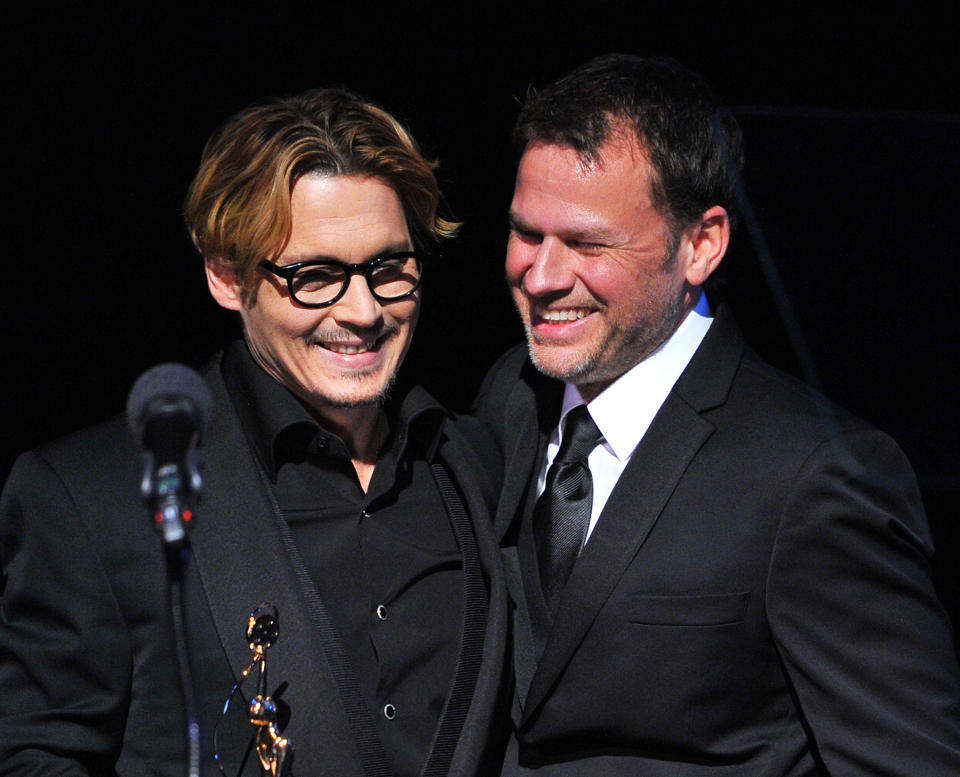 Actor Johnny Depp (L) and make-up artist and presenter Joel Harlow are seen after Depp accepted the Distinguished Artisan Award at Make-Up Artists and Hair Stylists Guild Awards on Saturday, Feb. 15, 2014 at Paramount Studios in Los Angeles, California (Photo by Vince Bucci/Invision/AP)
