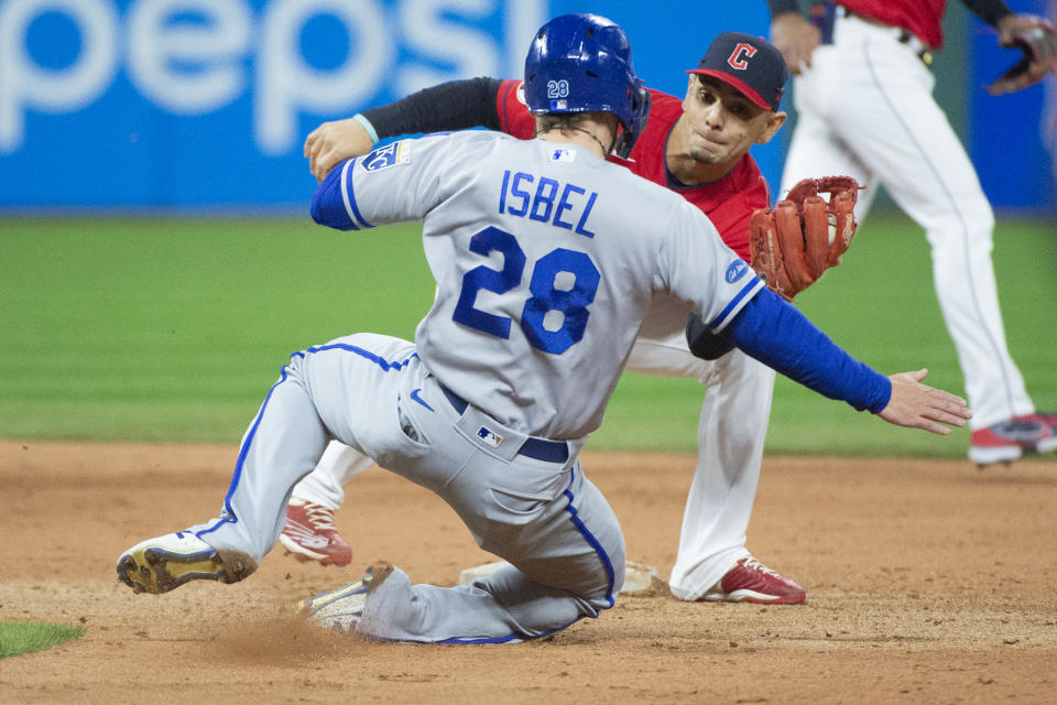 Cleveland Guardians' Andres Gimenez prepares to tag Kansas City Royals' Kyle Isbel out during a steal attempt during the sixth inning of a baseball game in Cleveland, Saturday, Oct. 1, 2022. (AP Photo/Phil Long)