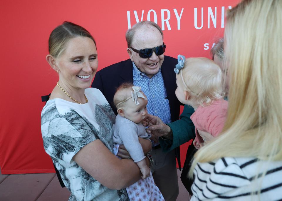 Ellis Ivory, center, talks with his great-grandchildren Daphne and Nora as the University of Utah, Ivory Family and The Church of Jesus Christ of Latter-day Saints celebrate the completion of the first of four student housing buildings at Ivory University House in Salt Lake City on Wednesday, Oct. 18, 2023. Daphne’s mother Mary Kate Ivory Bertha holds her. | Jeffrey D. Allred, Deseret News