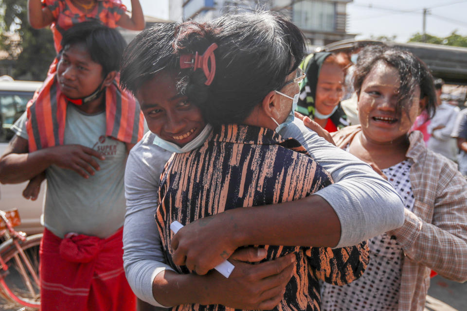 A released prisoner hugs a family member outside the Insein prison in Yangon, Myanmar Friday, Feb. 12, 2021. Myanmar's coup leader used the country's Union Day holiday on Friday to call on people to work with the military if they want democracy, a request likely to be met with derision by protesters who are pushing for the release from detention of their country's elected leaders. The new junta announced it would mark Union Day by releasing thousands of prisoners and reducing other inmates’ sentences. (AP Photo)