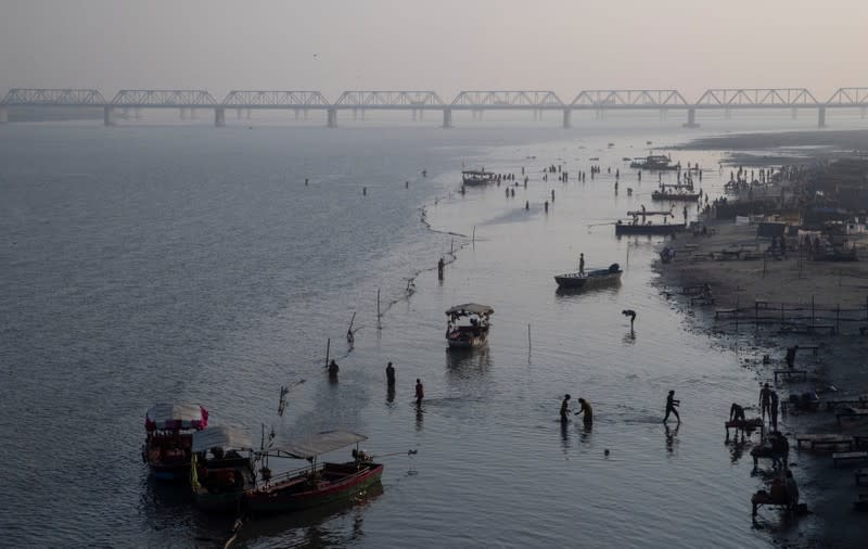 Hindu devotees pray on the banks of Sarayu river after Supreme Court's verdict on a disputed religious site, in Ayodhya