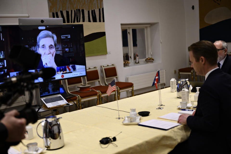 Danish Foreign Minister Jeppe Kofod, right, attends a video conference together with other EU-leaders, meeting with US Special Presidential Envoy for Climate John Kerry, seen on screen, in Copenhagen Denmark, Friday, Jan. 22, 2021.
