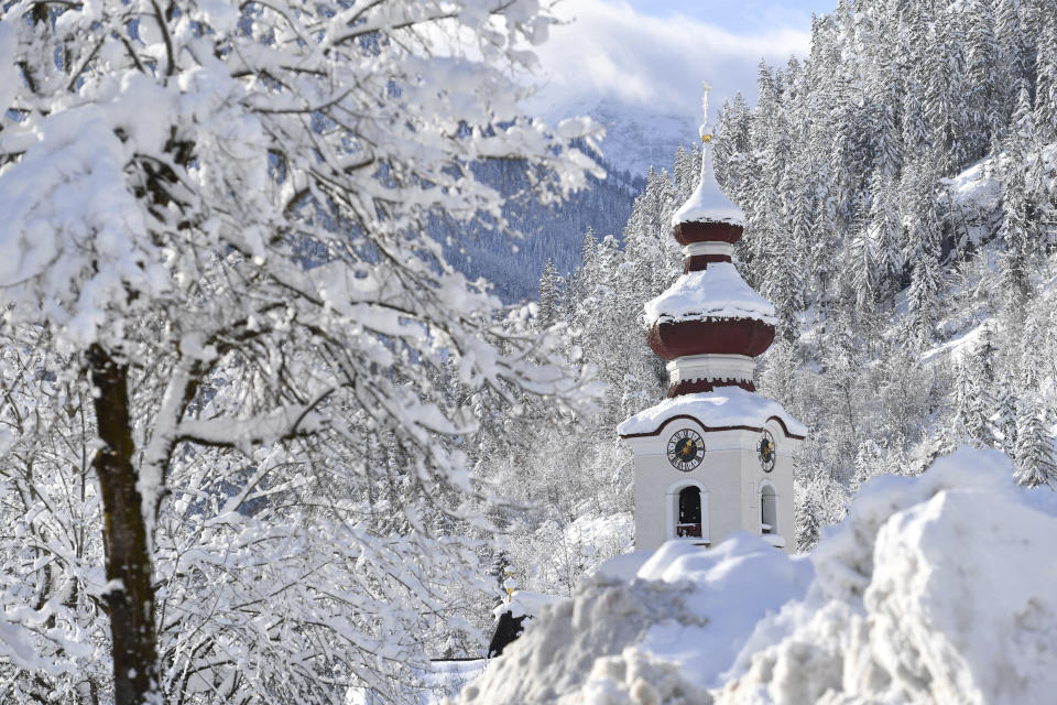 The steeple of the Loferer church is seen through the snow on Friday, Jan. 11, 2019 in Lofer, Austrian province of Salzburg.(AP Photo/Kerstin Joensson)