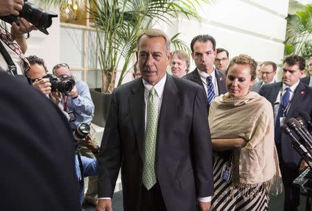 Speaker of the House John Boehner (R-OH) is followed by reporters after a Republican caucus meeting at the Capitol in Washington, in this August 1, 2014 file photo. REUTERS/Joshua Roberts/Files