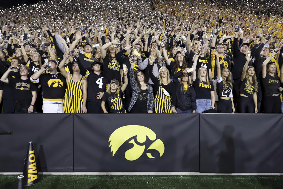 FILE - In this Saturday, Sept. 22, 2018 file photo, Iowa fans wave to children in the University of Iowa Stead Family Children's Hospital at the end of the first quarter of an NCAA college football game against Wisconsin in Iowa City, Iowa. During a season when the atmosphere will be subdued at Iowa home football games because the usual 69,000 fans won't be there, one tradition will go on uninterrupted. At the end of the first quarter, players and coaches from both teams will turn to the University of Iowa Stead Family Children’s Hospital and wave, just as they've done every home game since 2017.(AP Photo/Matthew Putney, File)