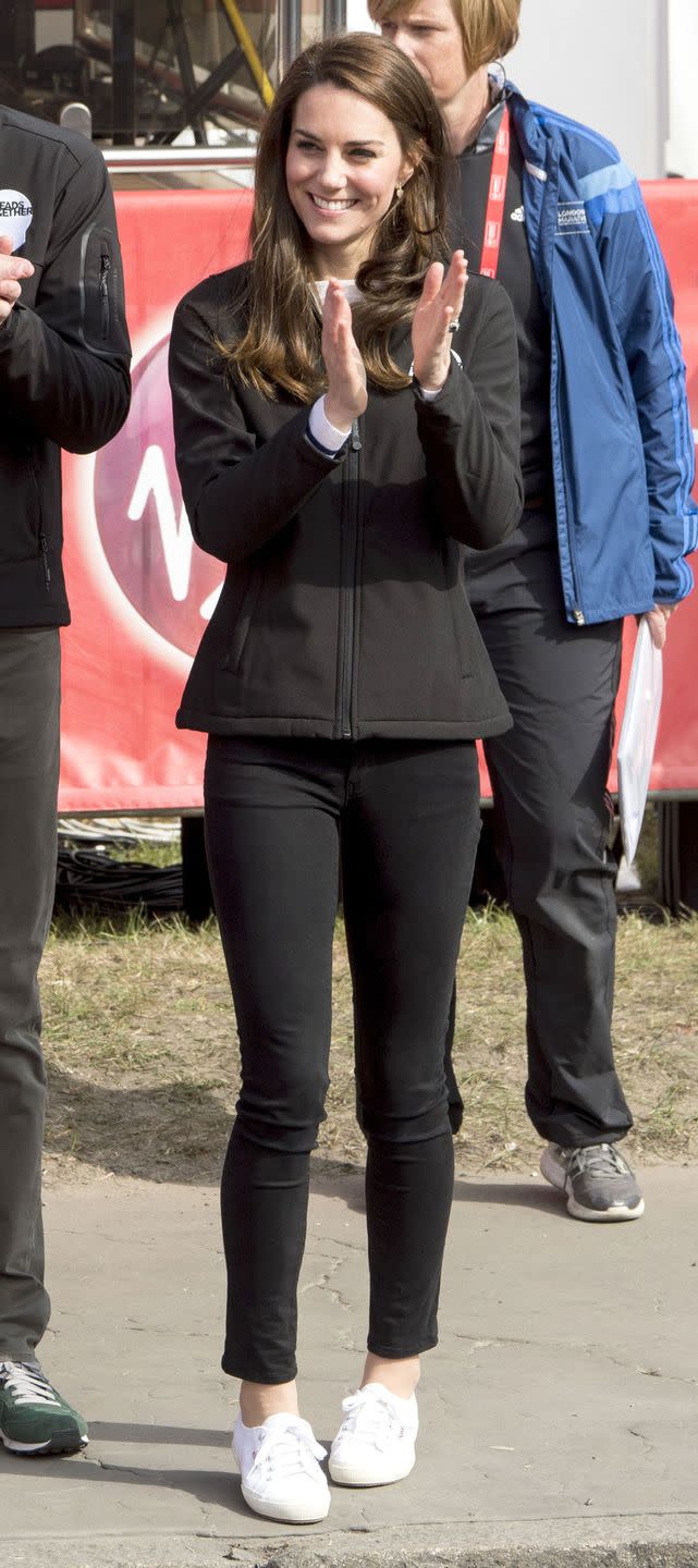 <p>In a zip-up jacket with black cropped jeans and Superga sneakers at the blue start of the Virgin Money London Marathon.</p>