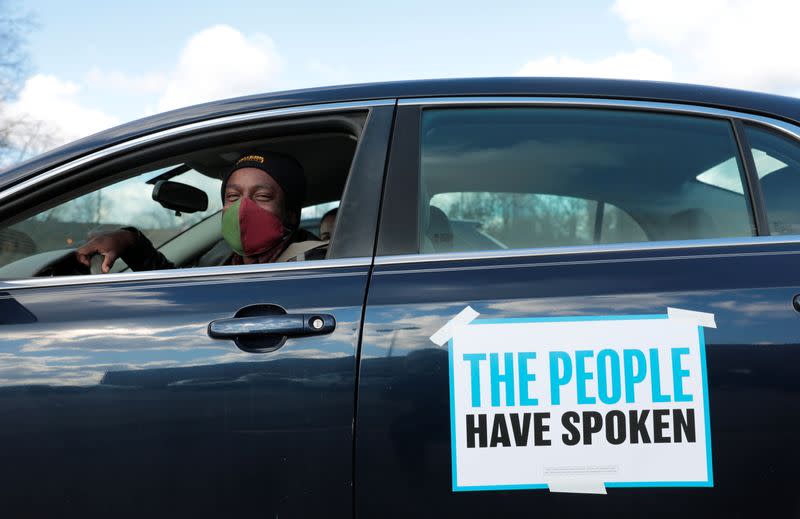 Tristan Taylor demonstrates in a car caravan as the Board of State Canvassers meet to certify the results of the election