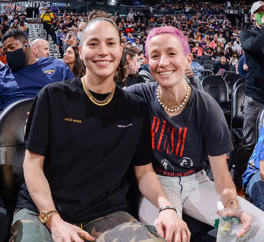 Andrew D. Bernstein/NBAE via Getty Sue Bird #10 of the Seattle Storm and Soccer Player, Megan Rapinoe attend a game between the Dallas Mavericks and Phoenix Suns on November 19, 2021 at Footprint Center in Phoenix, Arizona. NOTE TO USER: User expressly acknowledges and agrees that, by downloading and or using this photograph, user is consenting to the terms and conditions of the Getty Images License Agreement. Mandatory Copyright Notice: Copyright 2021 NBAE