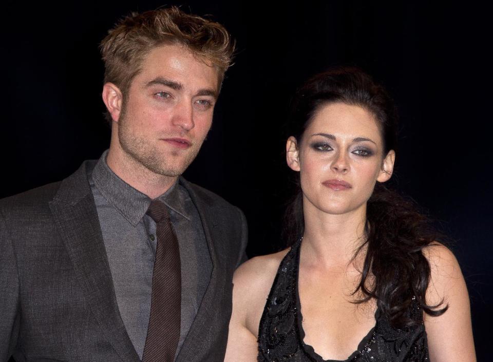 FILE - In this Nov. 16, 2011 file photo, British actor Robert Pattinson, left, and US actress Kristen Stewart arrive at the UK film premiere of